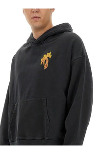 Palm Angels men’s black oversized hoodie with gold embroidered palm tree logo on chest in cotton fabric