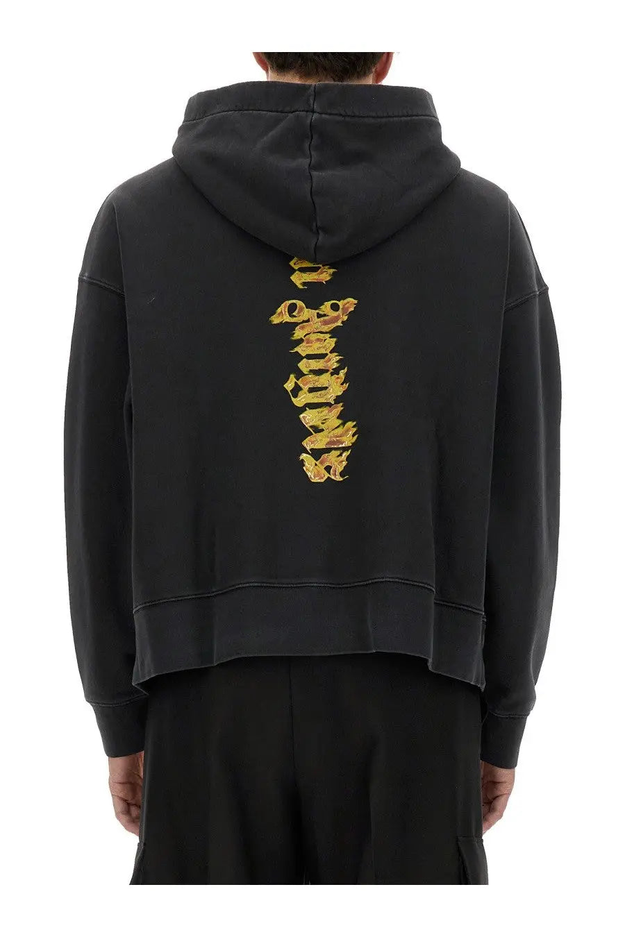 Back view of palm angels men’s black hoodie with vertical gold flame graphic on cotton fabric