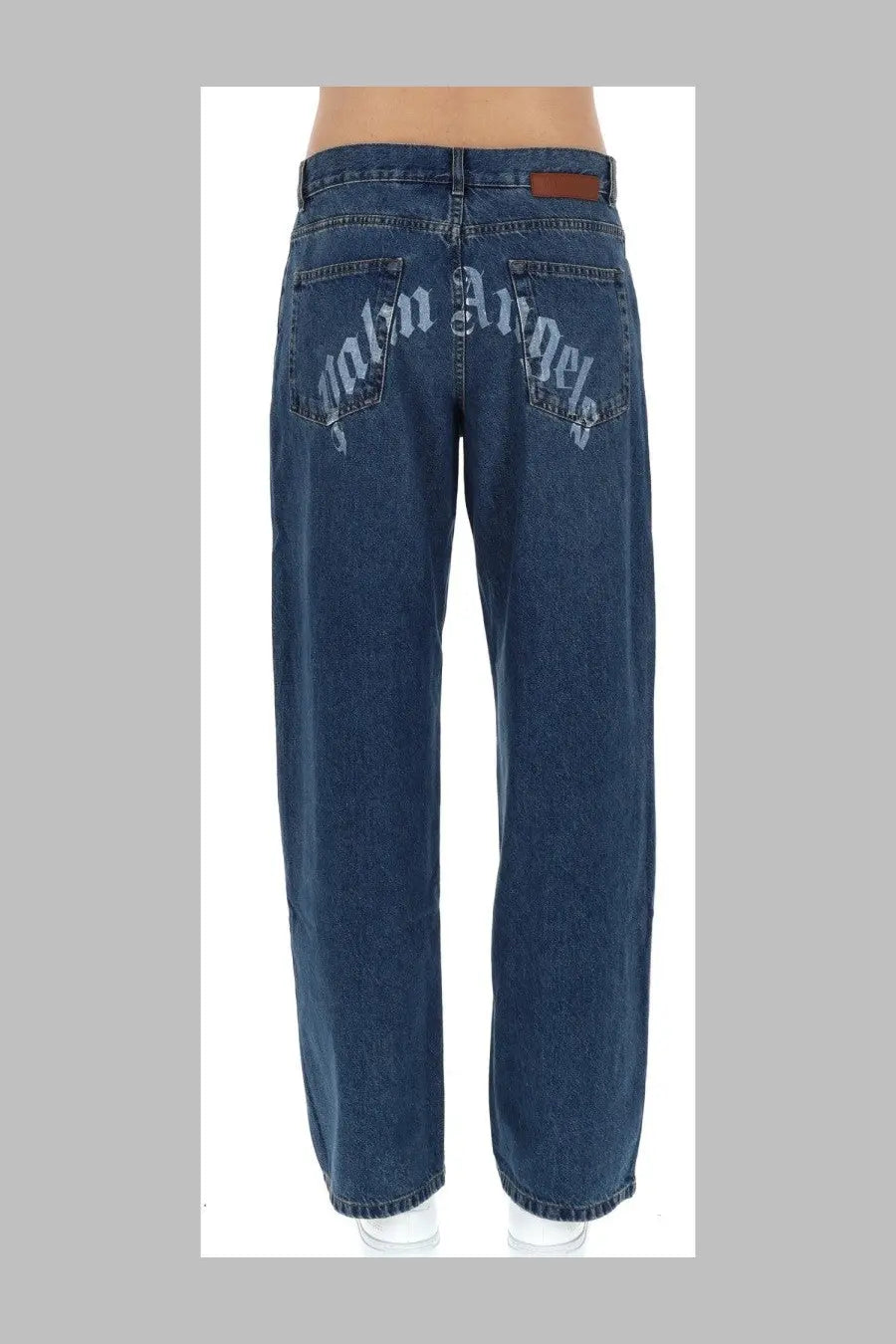 Back view of palm angels men’s curved blue jeans in dark blue denim with faded embroidered palm angels logo on pockets