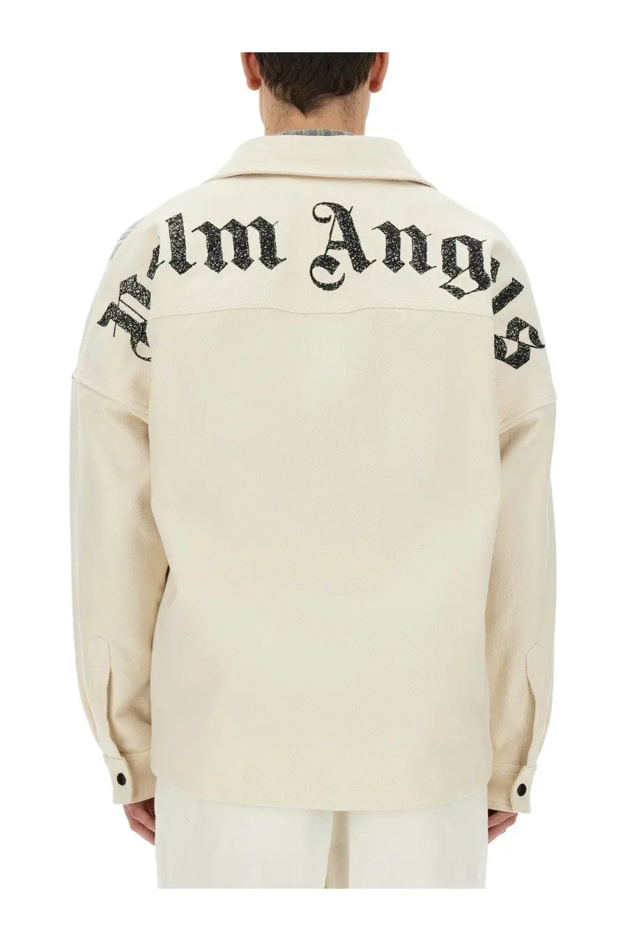 Cream-colored Palm Angels men’s overshirt with black embroidered logo across the shoulders shown from the back side