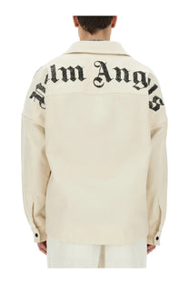 Cream-colored Palm Angels men’s overshirt with black embroidered logo across the shoulders shown from the back side