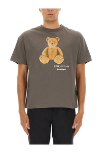 Palm Angels men’s grey short-sleeved t-shirt with textured golden bear graphic and bear in mind text on front