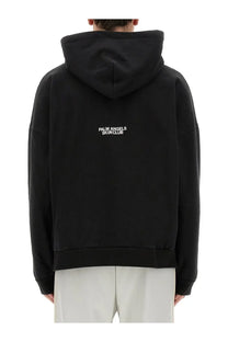 Back side of black palm angels men’s palm ski club sweatshirt with white embroidered branding on cotton fabric