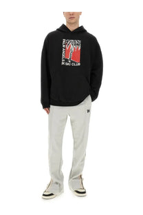 Black palm angels men’s hoodie with bold red and white palm tree graphic and ski club text on the front
