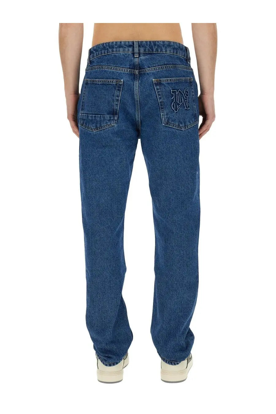 Back side of palm angels men’s straight leg blue denim jeans with stitched embroidered logo on the right pocket