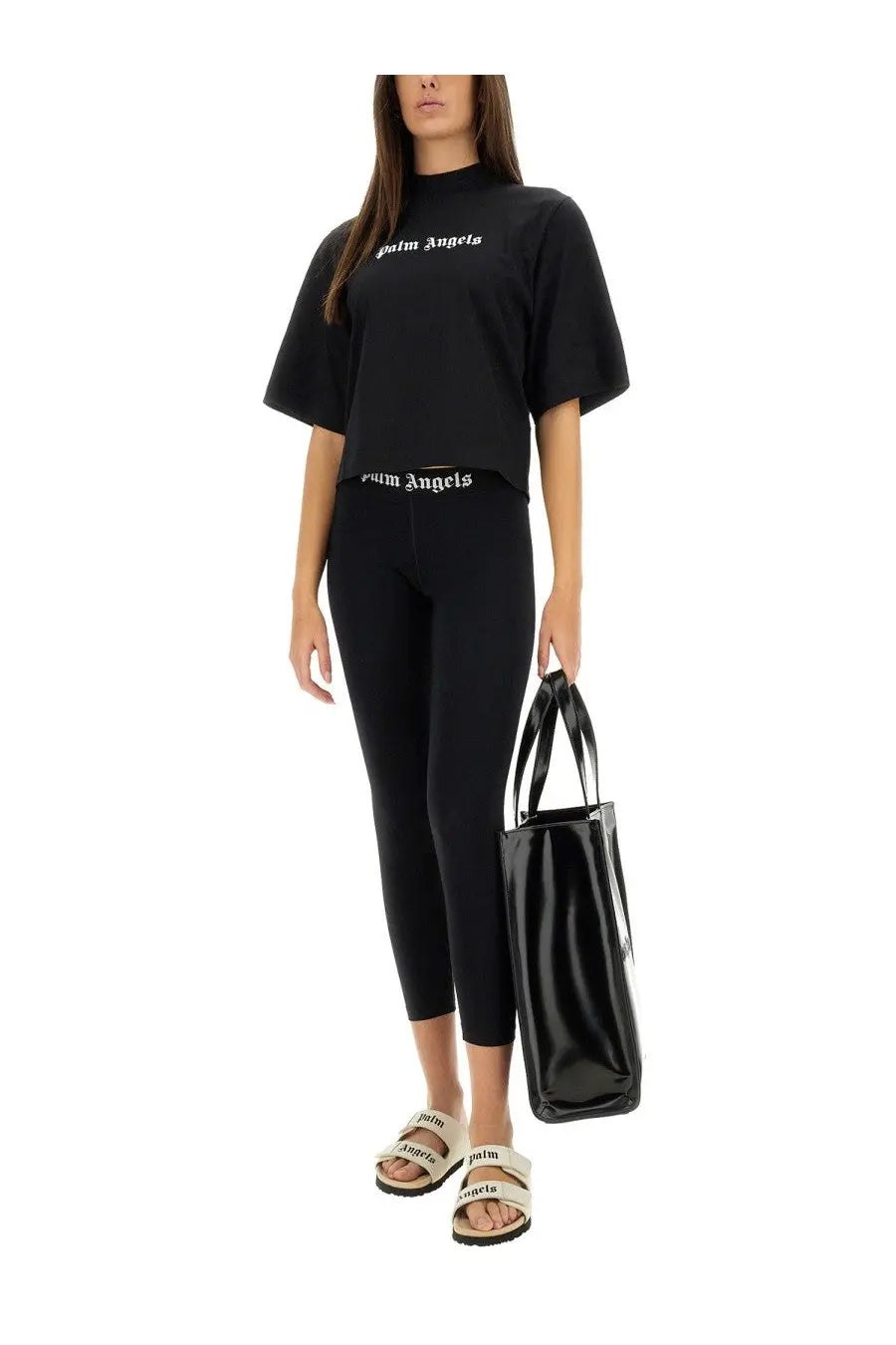 Black glossy leather tote bag with white palm angels logo stripes ideal for stylish everyday use