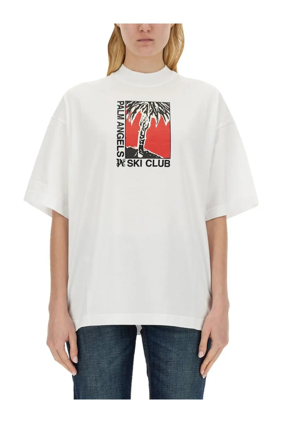 White oversized palm angels women’s t shirt with bold palm tree graphic and palm angels ski club text on red background