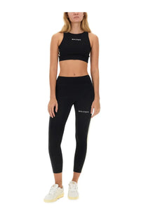 Black palm angels women’s crop top and leggings set with white logo branding for casual and athletic wear