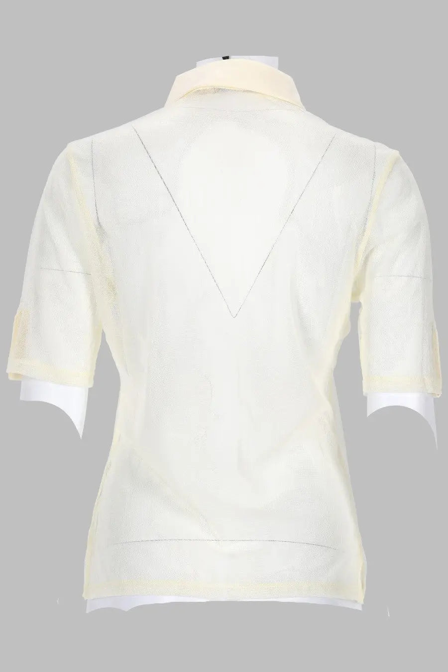 Back view of paloma wool women’s cream-colored short-sleeved blouse with v-shaped seam detail and white lining