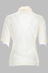 Back view of paloma wool women’s cream-colored short-sleeved blouse with v-shaped seam detail and white lining