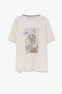 Off-white cotton t-shirt with vintage graphic of person holding artwork and dog accented by green ribbed neckline