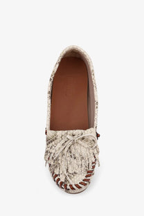 Cream-colored snake-print womens leather moccasin with brown leather accents and fringe detailing by Paris Texas