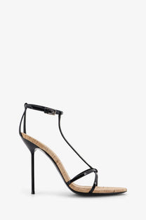Paris Texas women’s Lidia black patent leather strappy high heel sandal with cork insole and slender stiletto heel