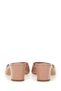 A pair of paris texas women’s sandalo lara pink nude patent leather mules with block heel and open back design