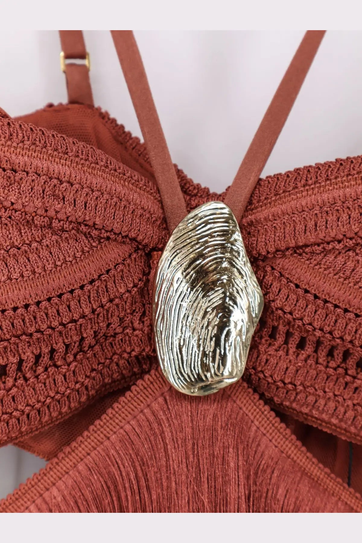 A metallic shell-shaped clasp with a textured reflective finish on the back of patbo womens amethyst fringed brown dress