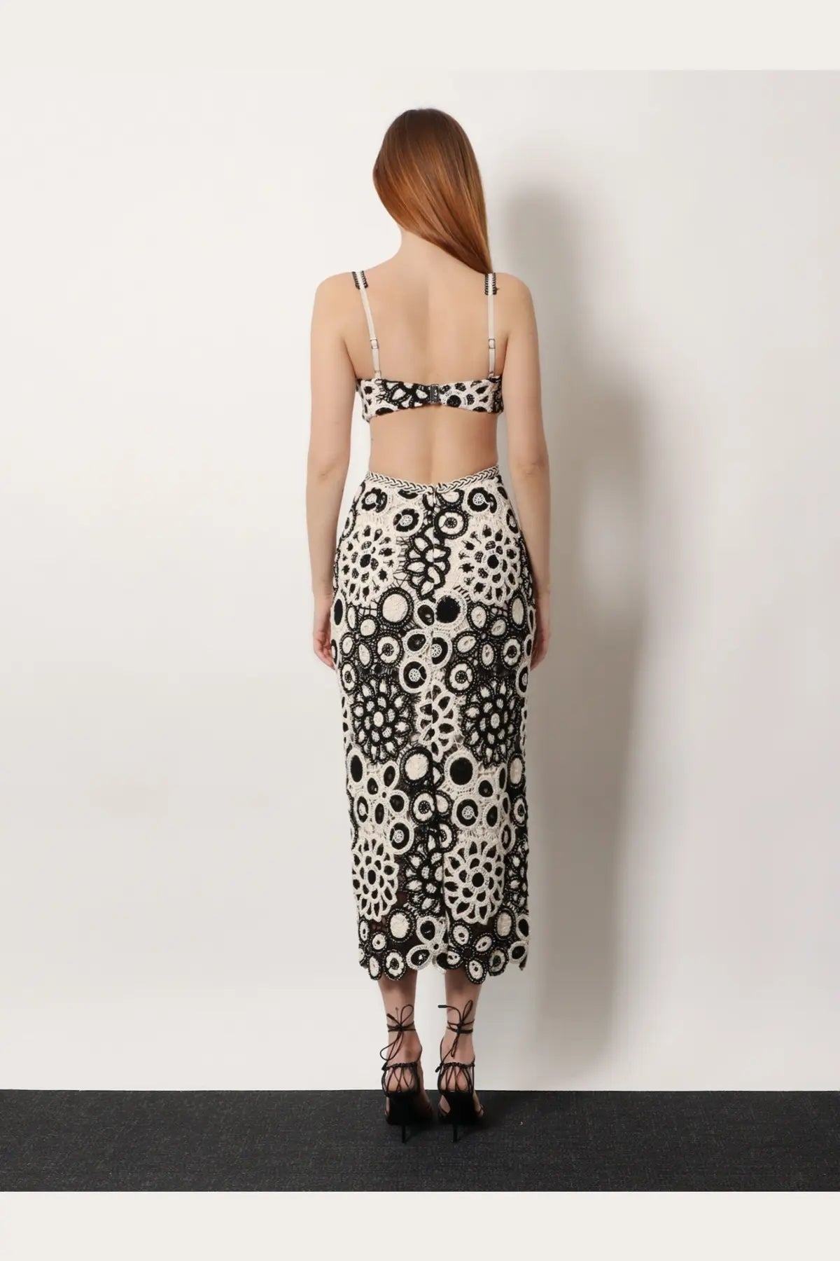 Patbo women’s black two-piece outfit with intricate circular lace crop top and high-waisted midi skirt