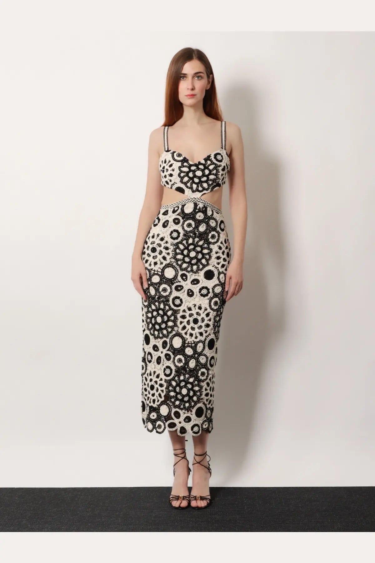 A woman wears a patbo women’s long crochet dress in black with intricate circular bead patterns in a two-piece style