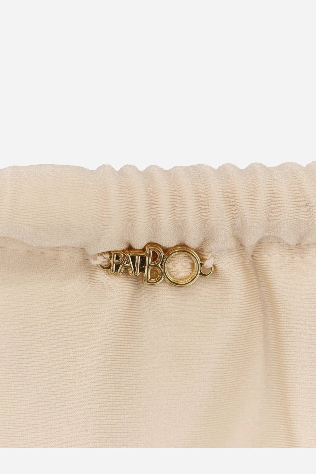 Gold-tone metal pabo tag on the elastic waistband of beige satin Patbo women’s lycra bikini bottoms white