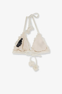 Cream-colored lycra triangle bikini top with ruffled edges and fluffy pom-pom details by Patbo women’s beachwear