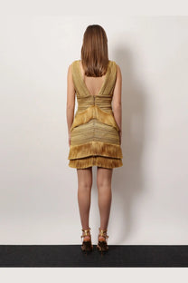 Patbo women’s pampas mini dress in gold with textured fabric layered fringe and deep v-back shown from the back side