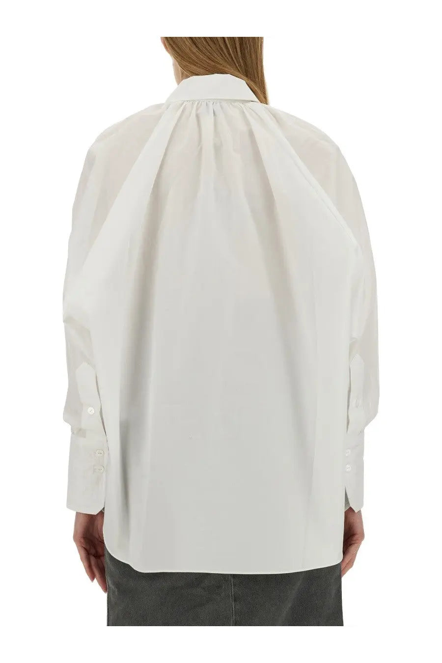 Patou women’s white cotton blouse with oversized button-down design and subtle pleats at the back visible