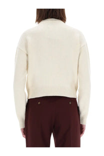 Cream-colored ribbed-knit sweater with high collar and long sleeves in patou women’s jersey white collection