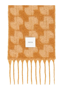 A soft caramel-colored Patou women’s JP scarf with a subtle geometric pattern and delicate fringe in beige
