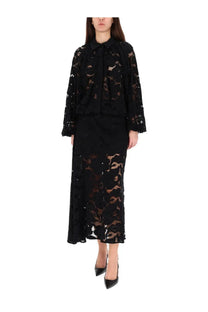Black lace blouse with bow neckline and long sleeves paired with patou women’s lace midi skirt black