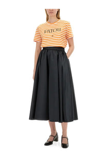Black satin high waist midi skirt with full flowing silhouette paired with patou women’s multicolor shirt