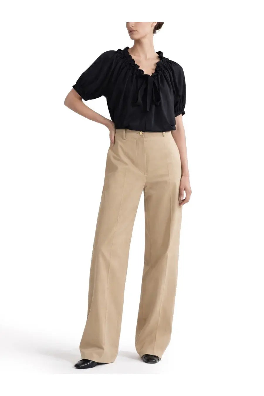 Beige wide-leg trousers with clean tailored fit and subtle front pleats paired with Patou women’s top volume black