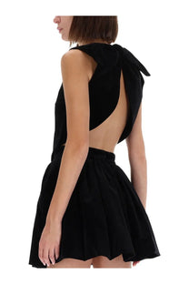 Back view of patou women’s black velvet mini dress featuring a bow detail perfect for evening wear