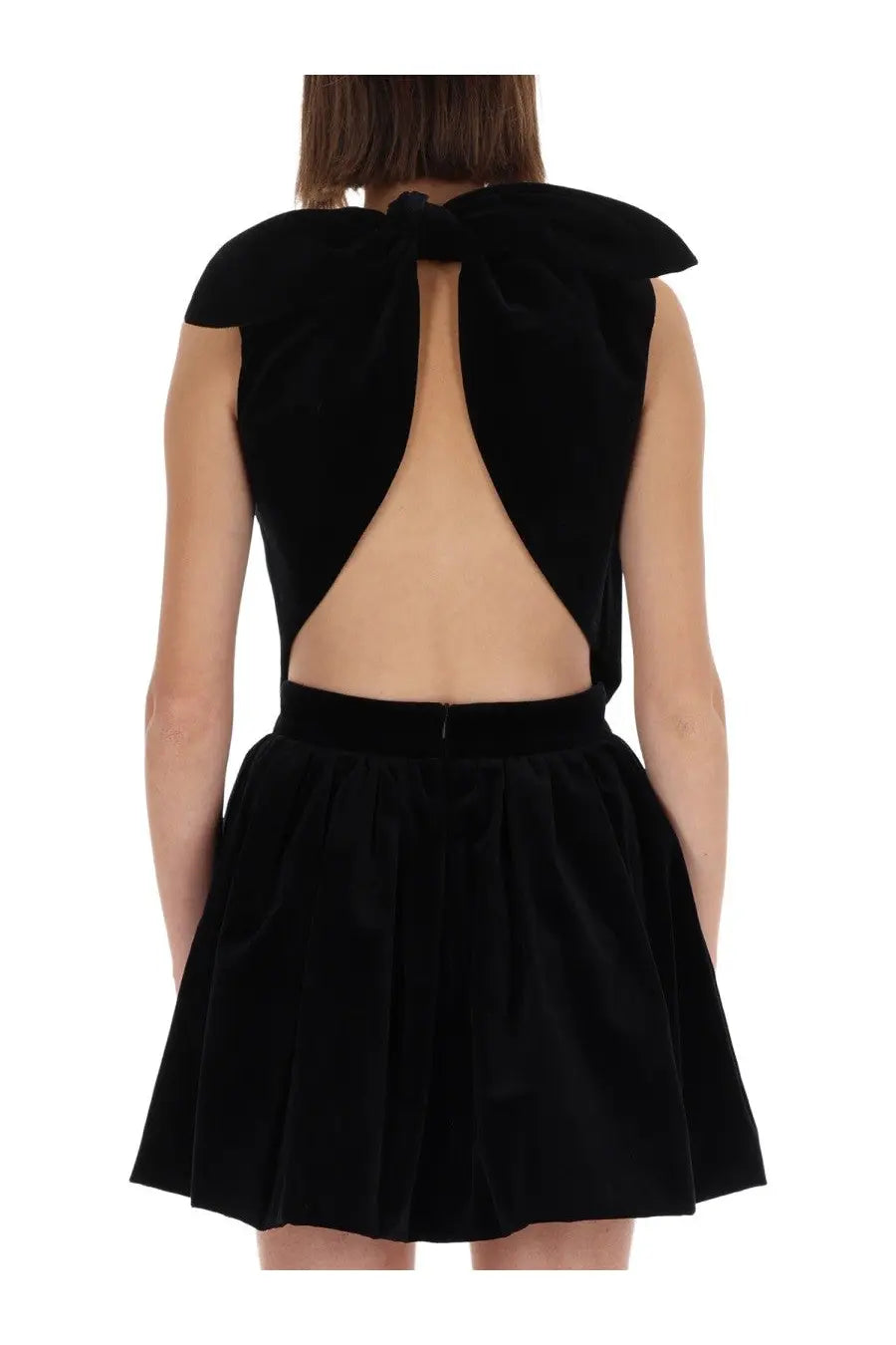 Back view of patou women’s black velvet mini dress with large bow and open-back design