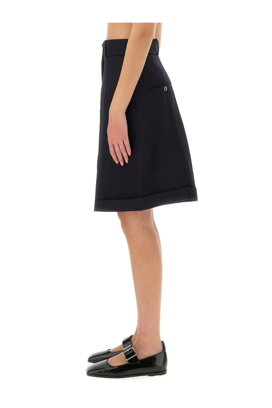 Black high-waisted a-line skirt with subtle pleats and silver button pocket detail shown with patou womens wool bermuda shorts blue