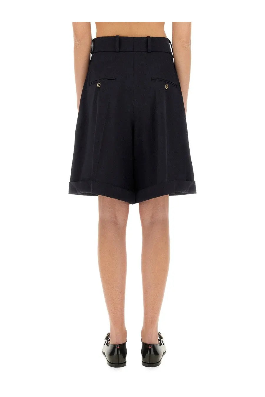 Black high-waisted Patou women’s wool Bermuda shorts with tailored fit gold button back pockets and rolled cuffs back view