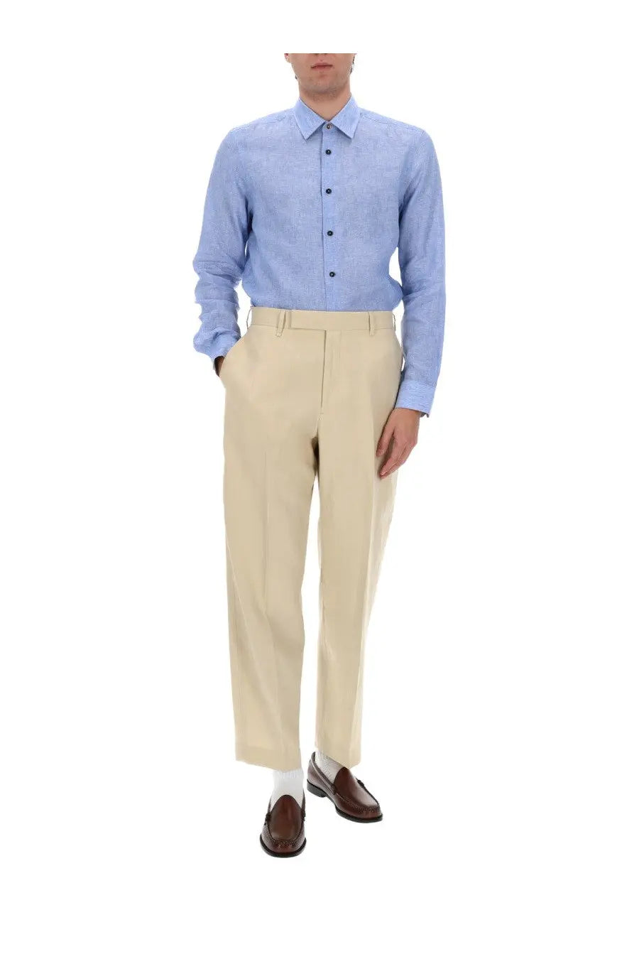 Light blue Paul Smith men’s button-down shirt with subtle textured weave and classic collar paired with beige trousers