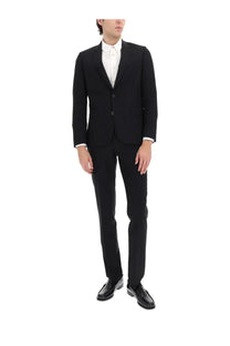 Paul Smith men’s two piece black tailored suit with three-button front and matching trousers over white dress shirt