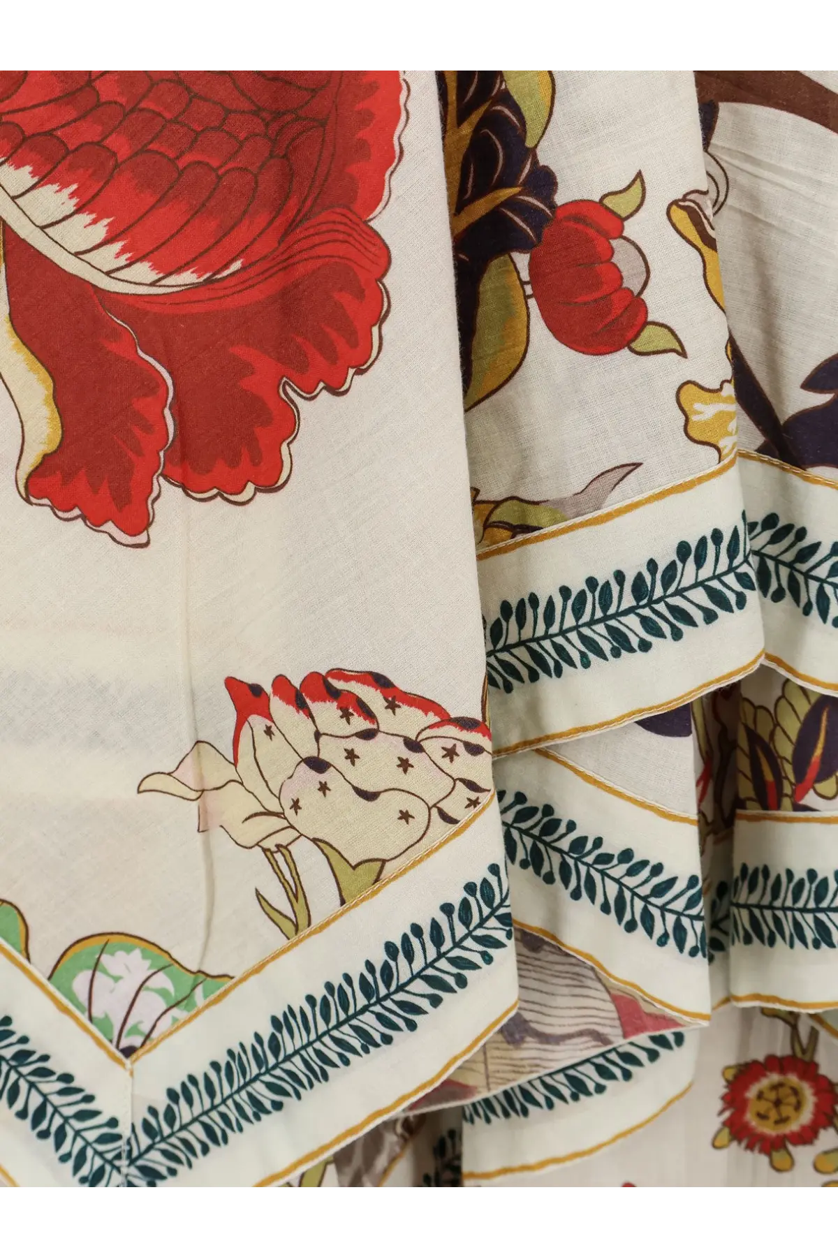 A cream-colored fabric scarf with vibrant red green and gold floral pattern paired with philippa 1970 women’s cova multicolor cotton dress white