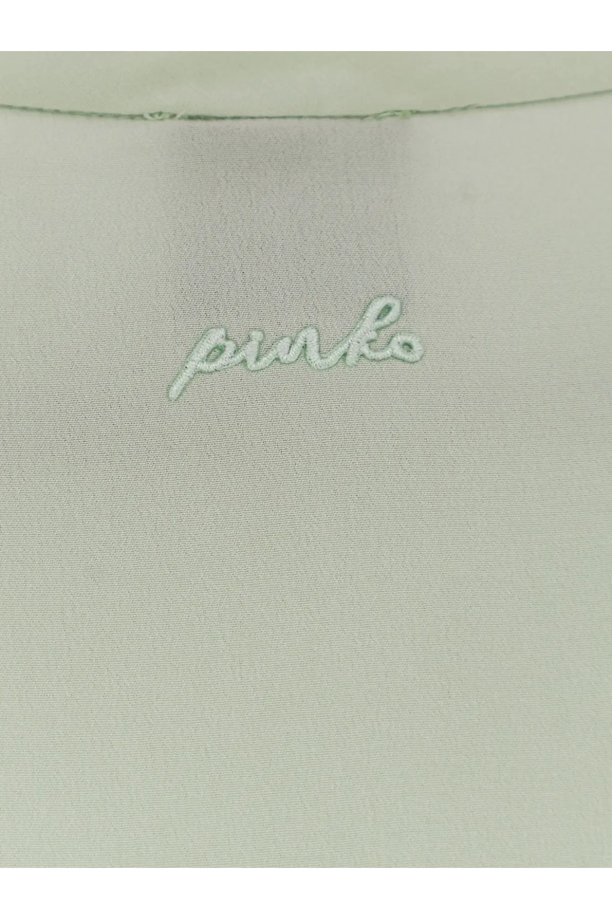 Light green satin fabric with pinko embroidered in matching thread on the back of pinko women’s blossom silk shirt green