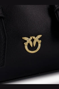 Pinko women’s black leather handbag featuring a gold-tone clasp with two stylized birds on a circular ring