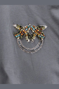 Pinko women’s grey cotton shirt featuring a sparkling multicolored rhinestone smiling face brooch with wing extensions