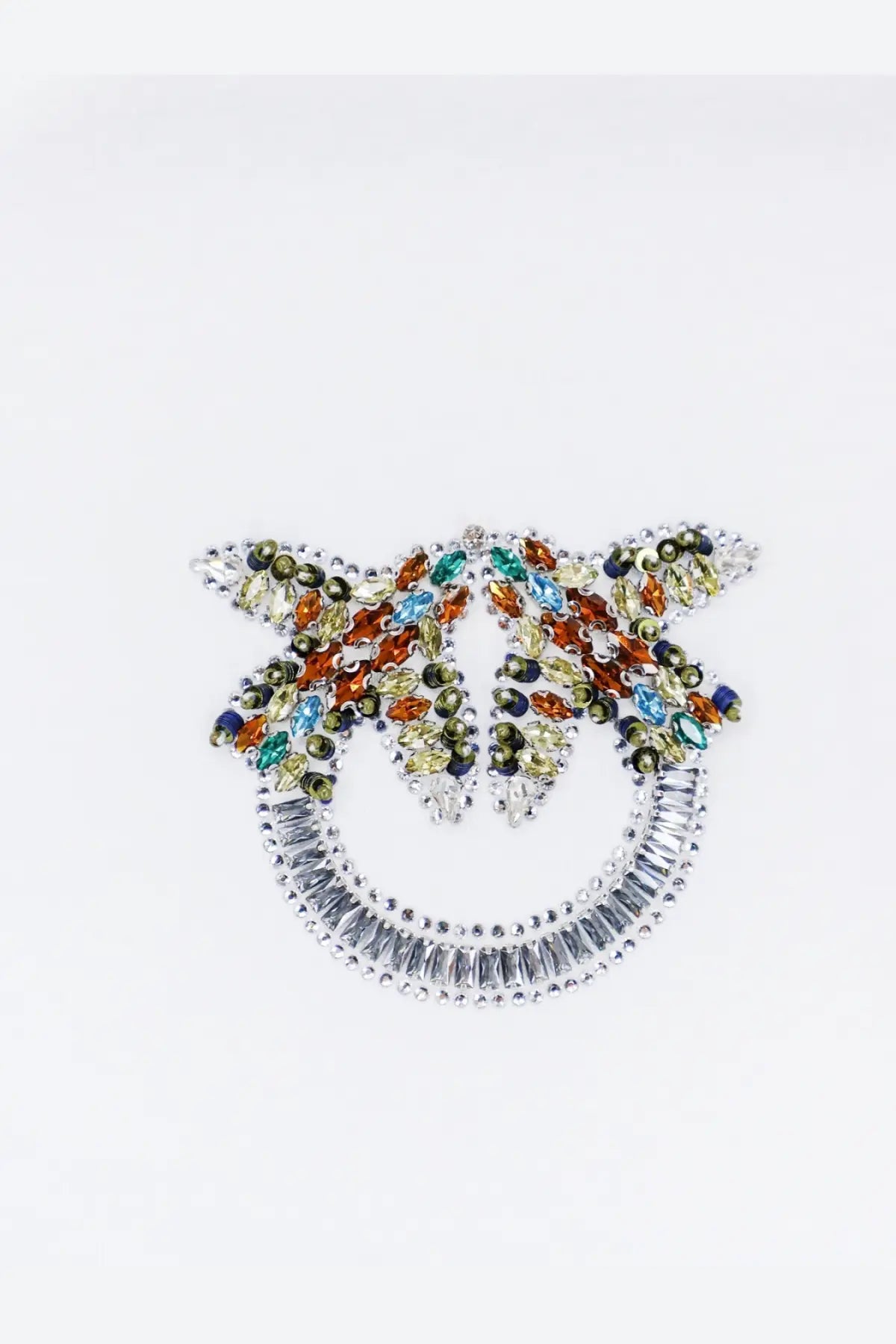 Pinko women’s white cotton shirt with a sparkling silver pinocchio brooch adorned with multicolored gemstones