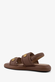 Pinko women’s fiona flat leather sandals in beige with brown leather straps and gold-tone circular buckles