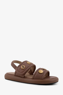 Pinko women’s fiona flat leather sandals in beige with brown leather straps and gold-tone circular buttons on platform sole