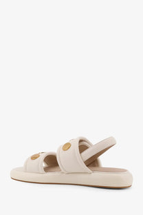 Pinko women’s Fiona low leather sandals in cream-colored suede with gold-tone circular buckles and thick flat sole