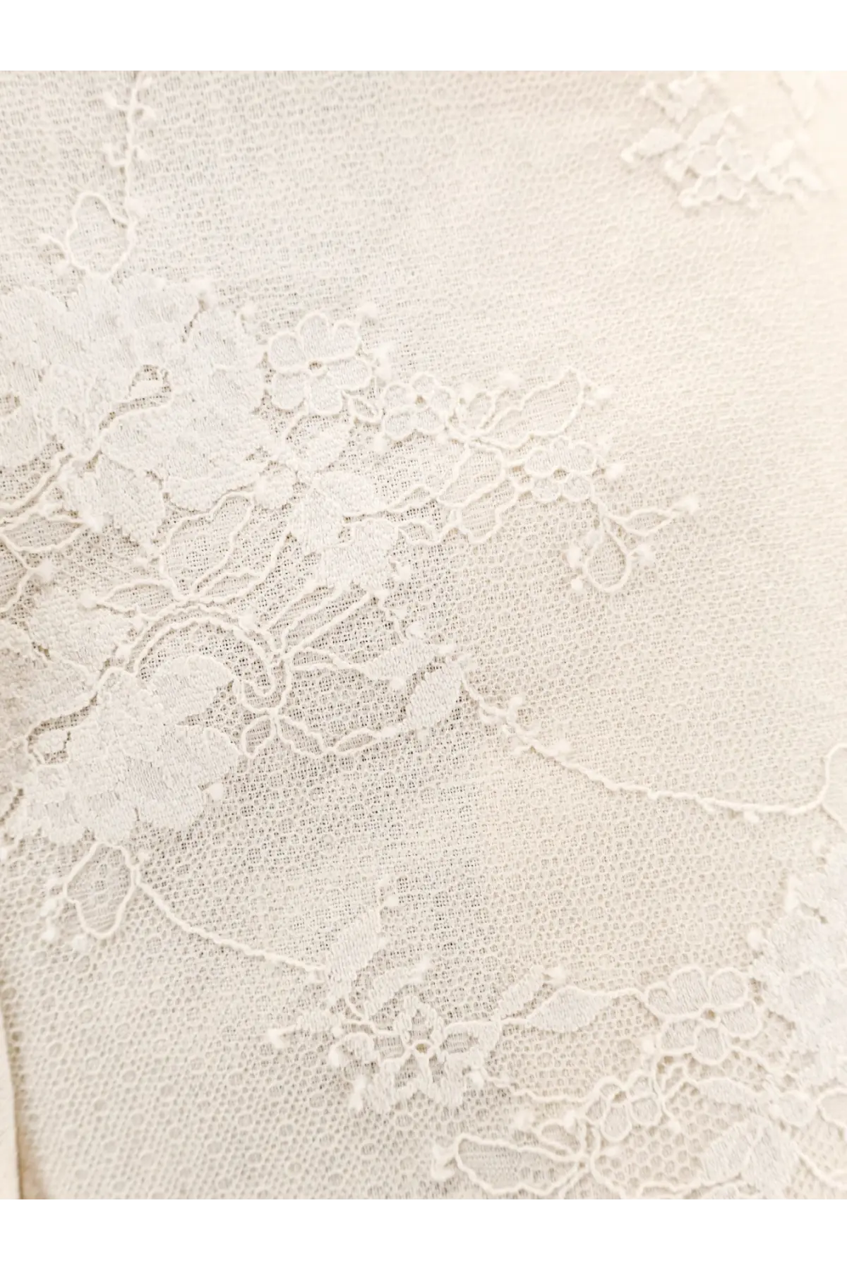 Pinko women’s ivy linen trousers beige shown with delicate ivory lace fabric featuring intricate floral patterns and sheer texture