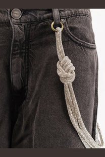 A sparkling silver beaded chain with a knotted design attached to black pinko women’s lauryn bull denim jeans