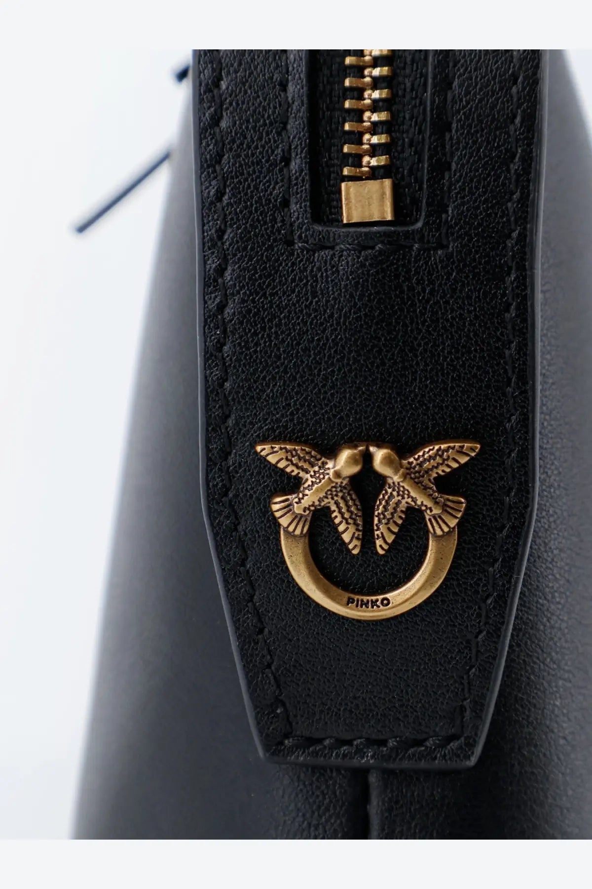 Pinko women’s black leather beauty case handbag with gold metal clasp featuring interlocking birds and Pinko engraving