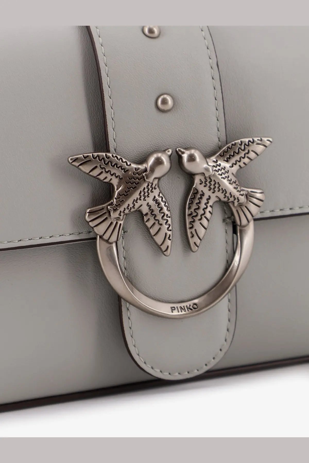 Silver-toned metal clasp with two detailed birds on a light gray leather Pinko women’s mini Love crossbody bag
