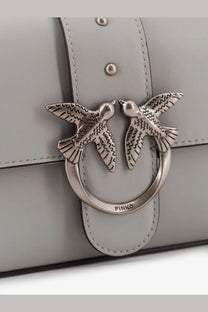 Silver-toned metal clasp with two detailed birds on a light gray leather Pinko women’s mini Love crossbody bag