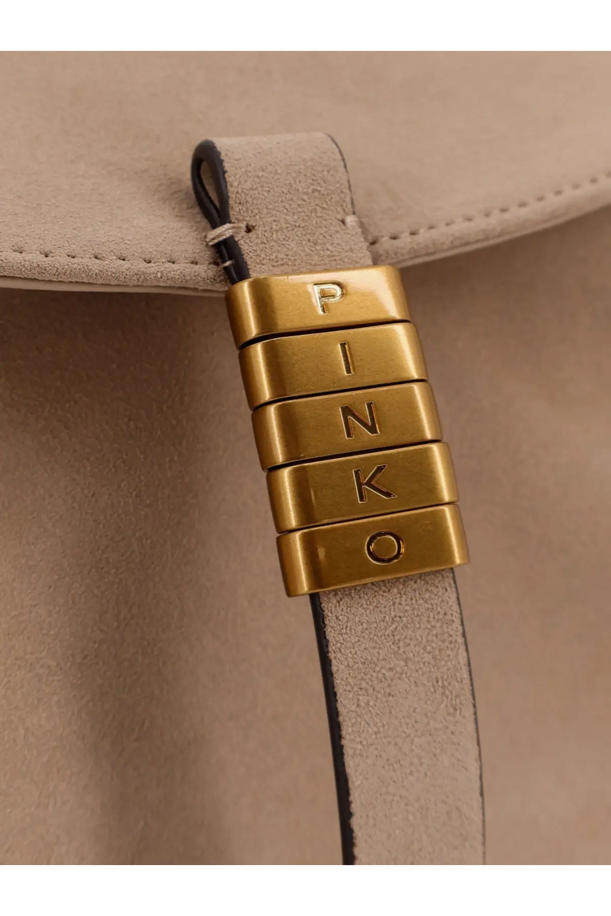 Gold-tone metal clasp engraved pinko attached to beige suede strap of pinko women’s suede crossbody bag